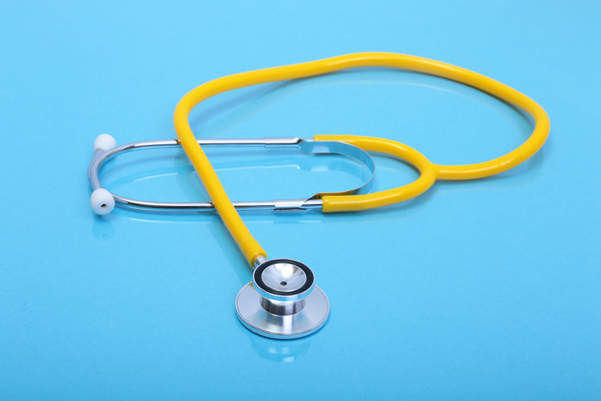 Stethoscope and medical equipmenton on blue background